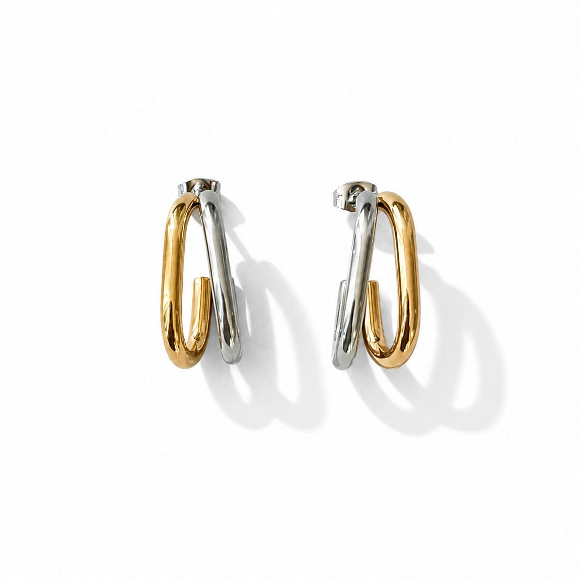 Pair of gold and silver hoop earrings on a white background