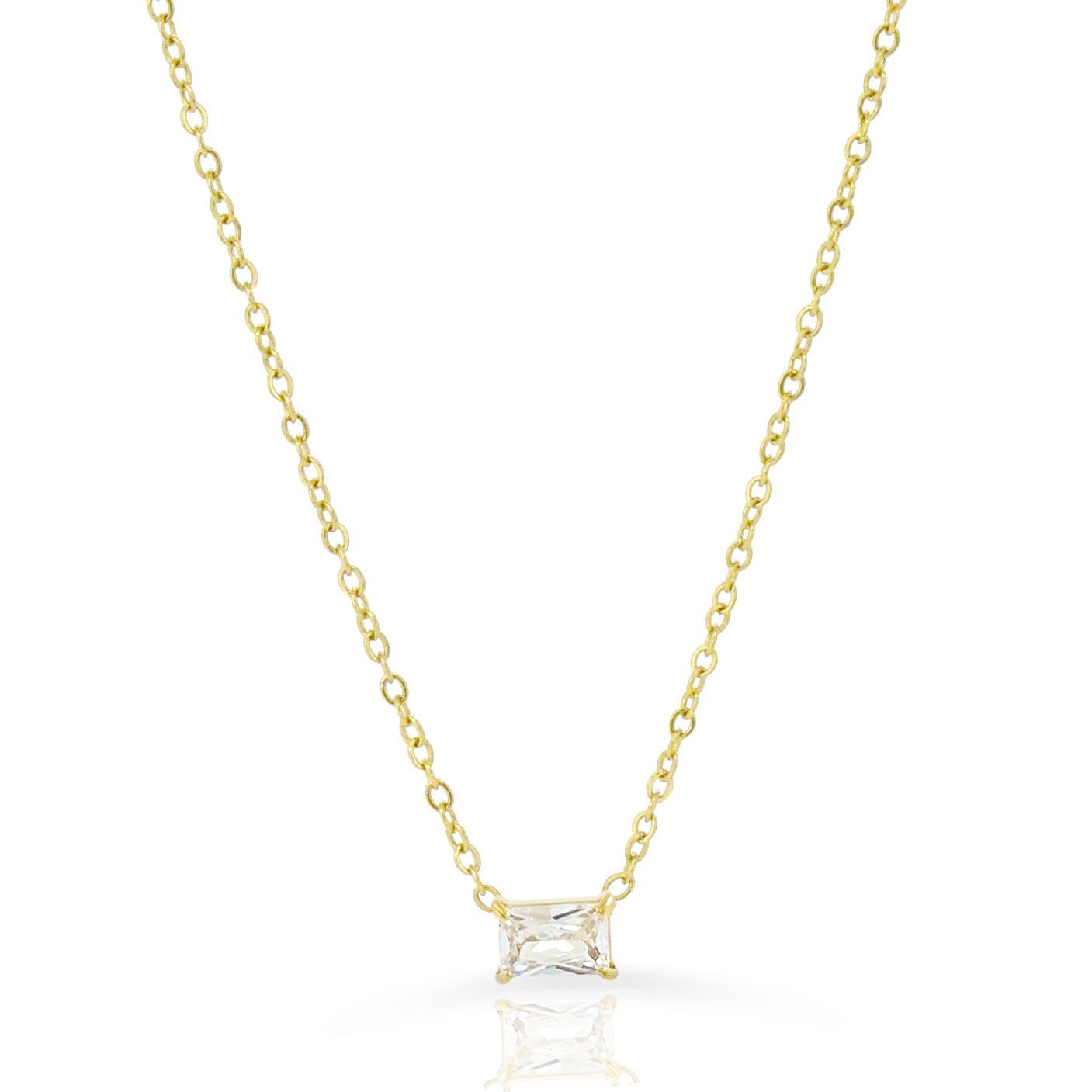 Gold necklace with a clear emerald cut pendant on a white background waterproof jewelry