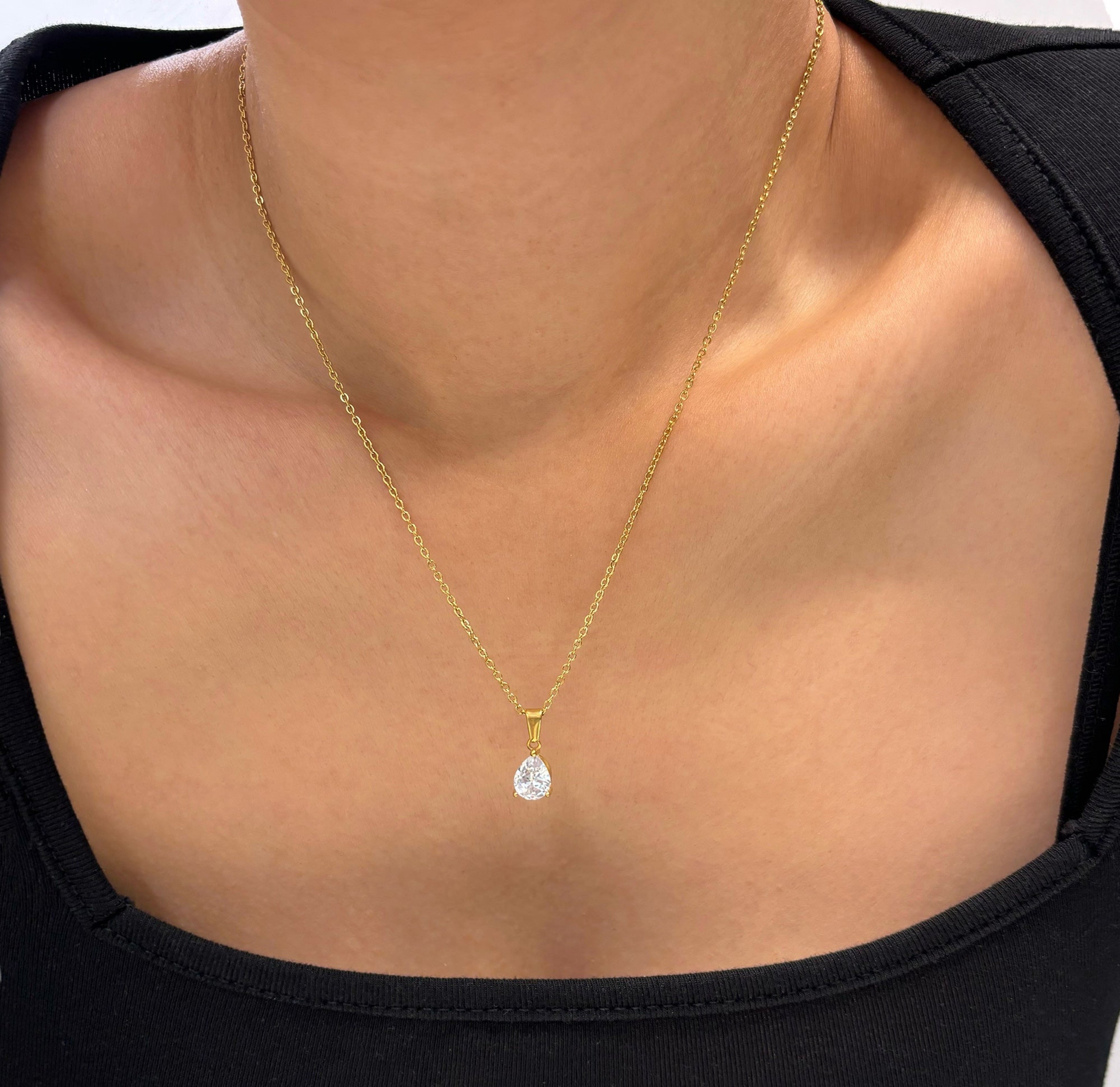 dainty white tear drop stone pendant necklace worn on model