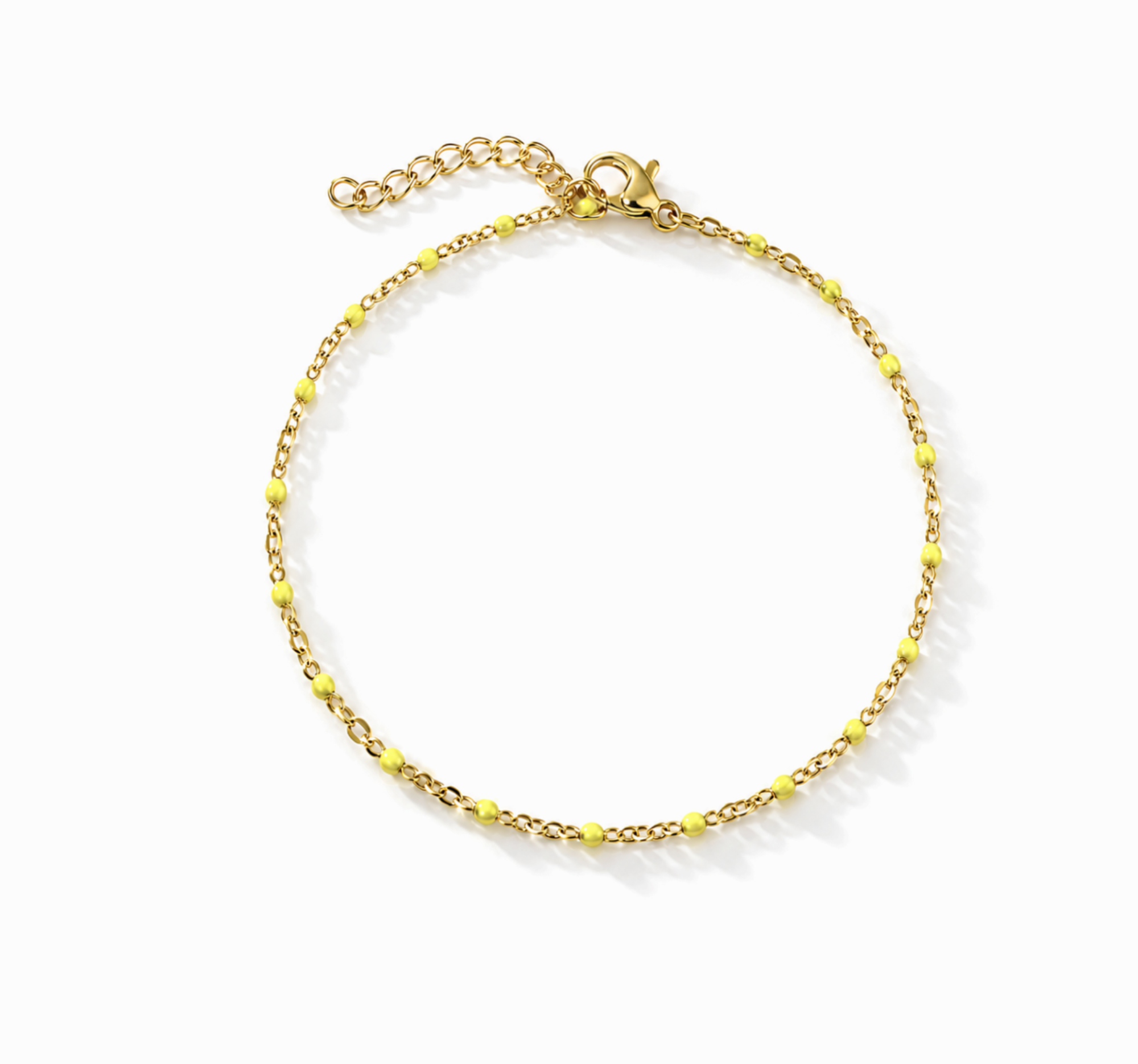 Gold anklet bracelet with yellow beads on a white background