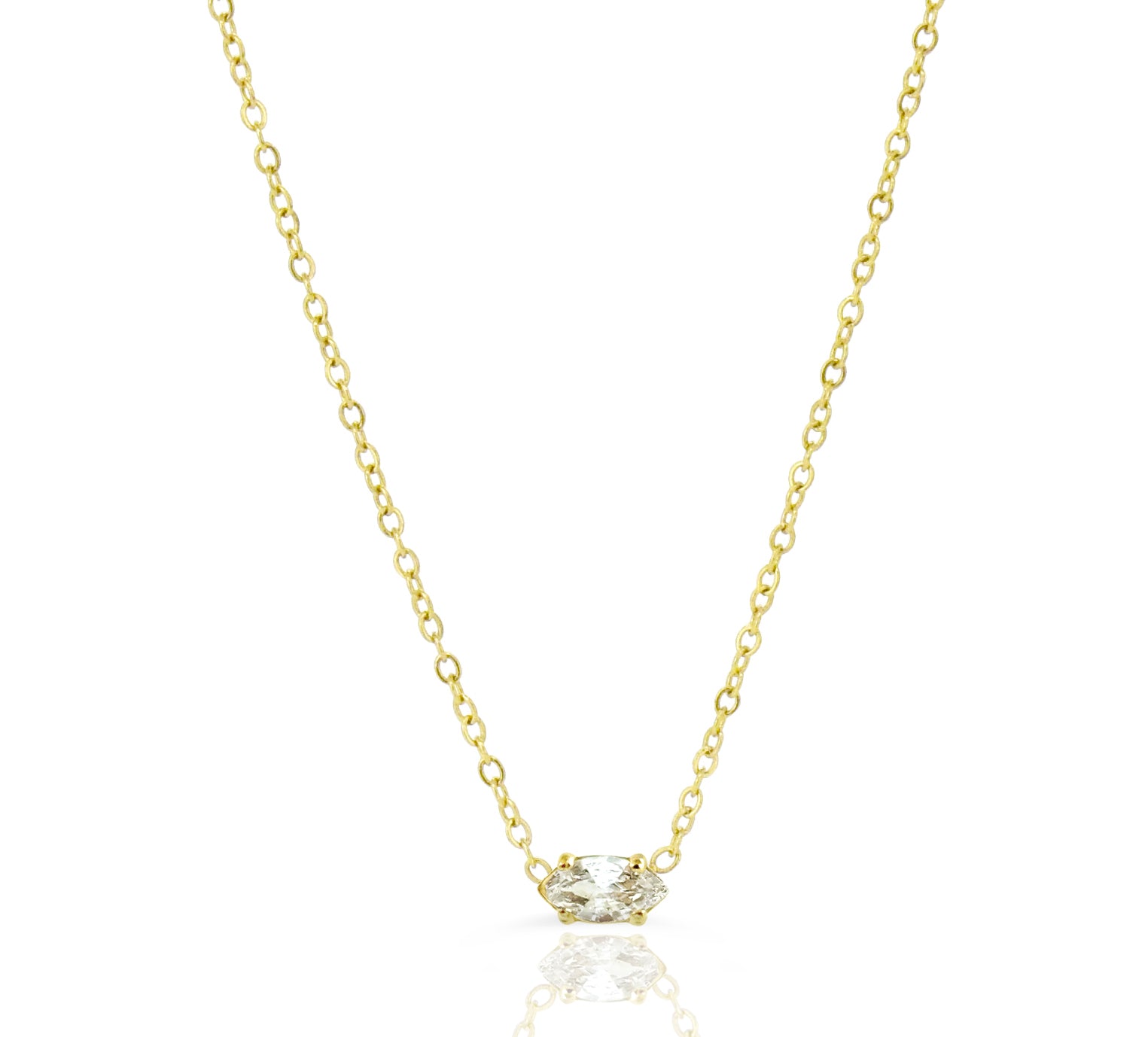 Dainty Gold necklace with a marquis gemstone on a white background
