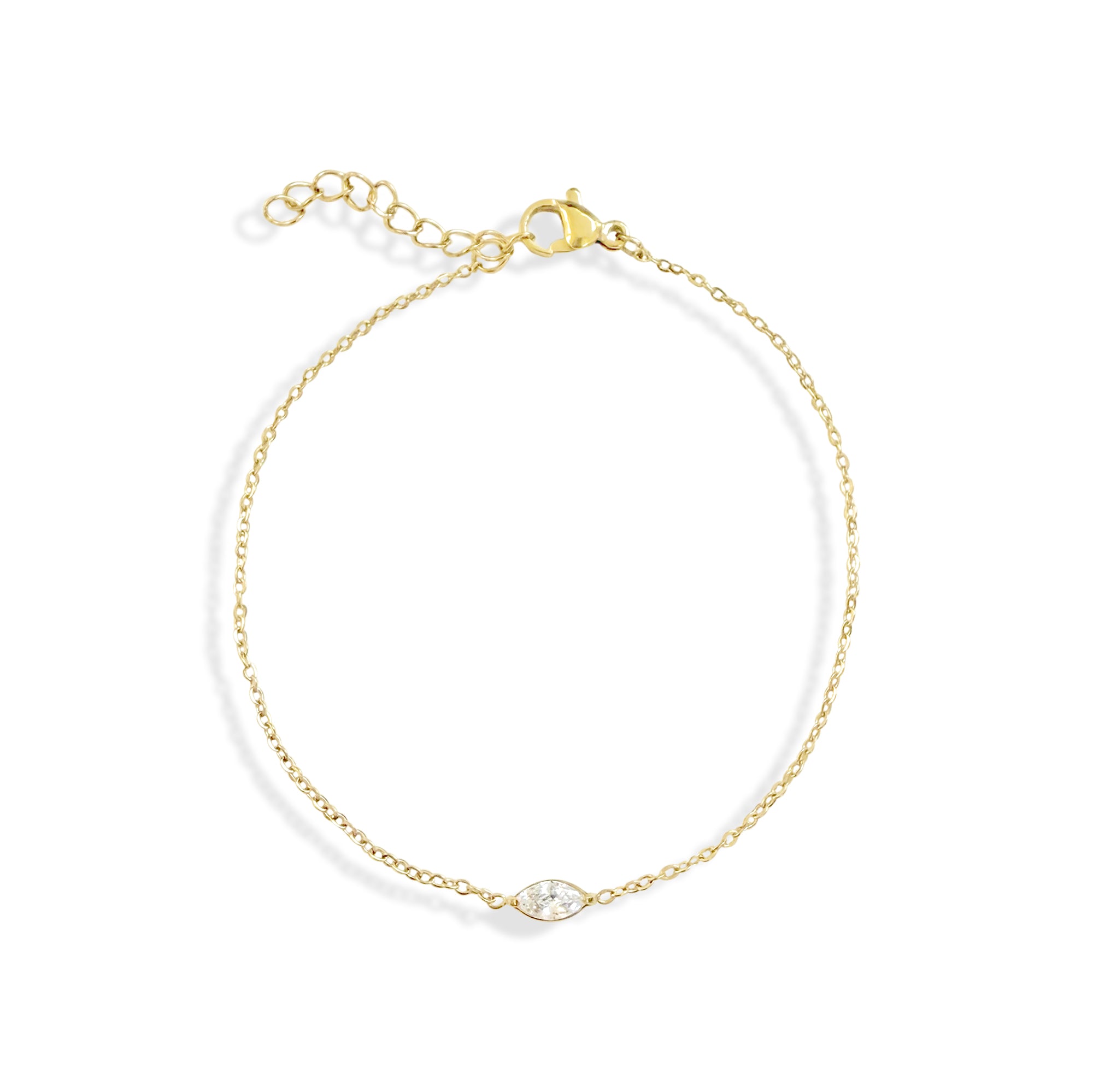 Gold bracelet with a clear gemstone on a white background