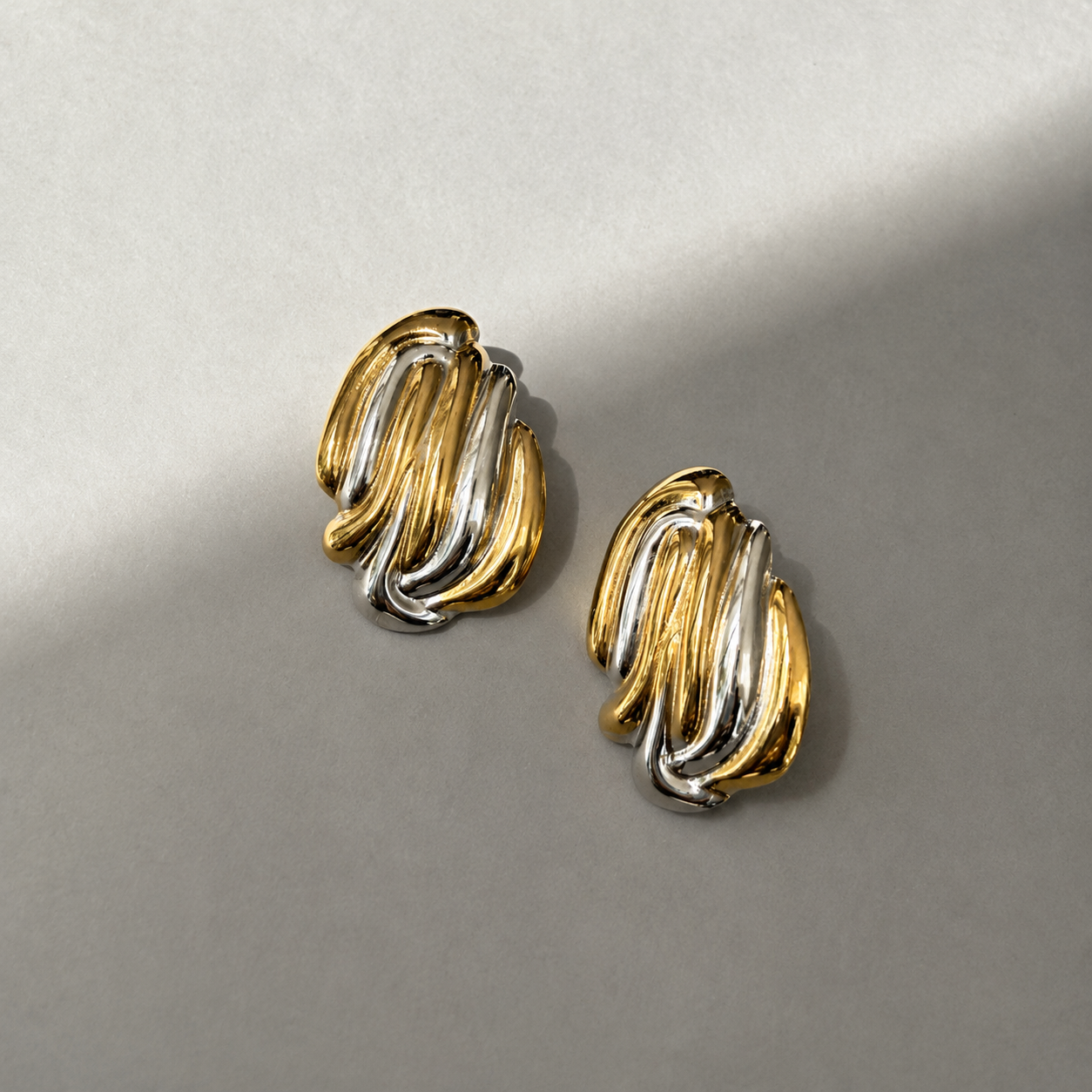 two tones woven statement earrings ob grey background