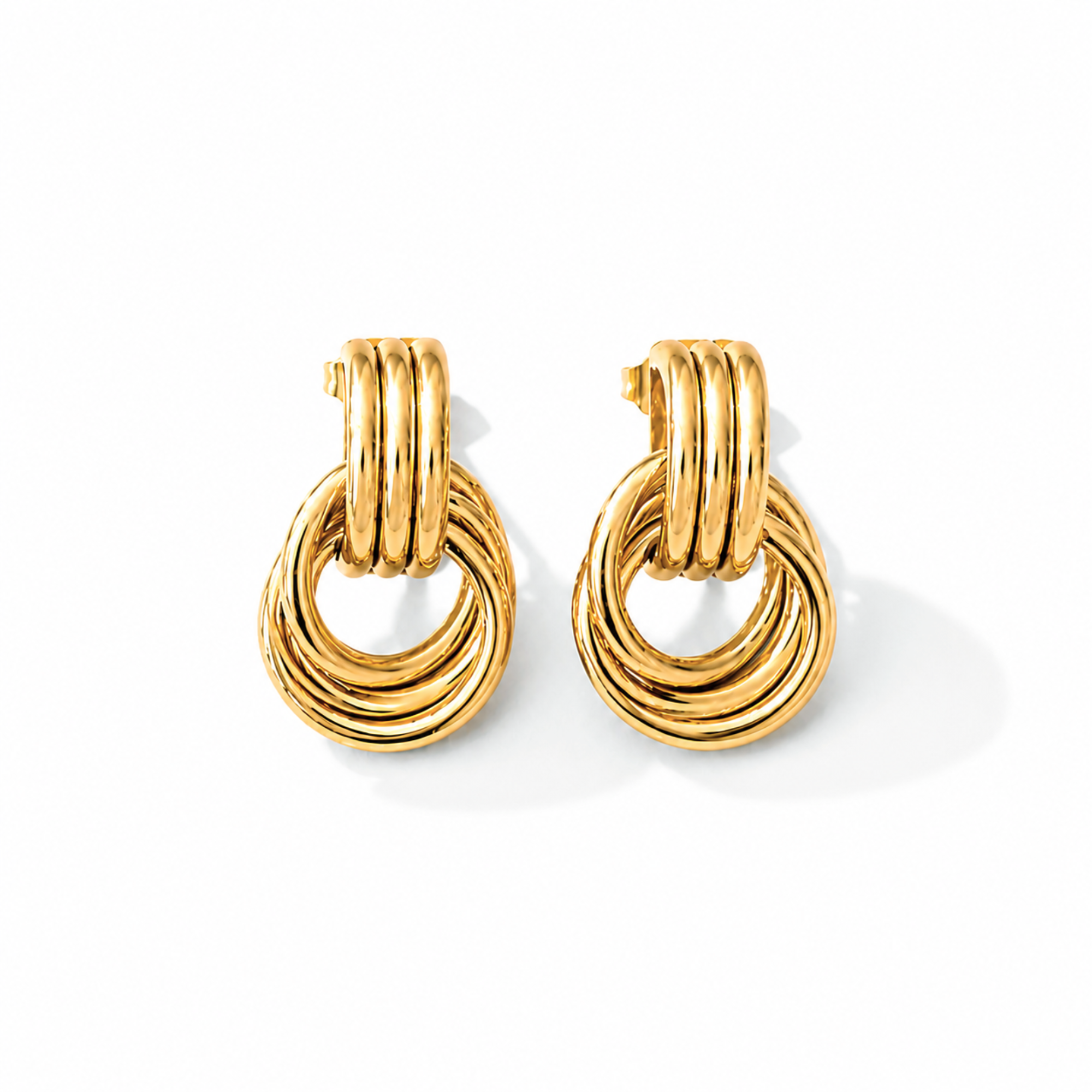 Pair of gold door knocker earrings on a white background