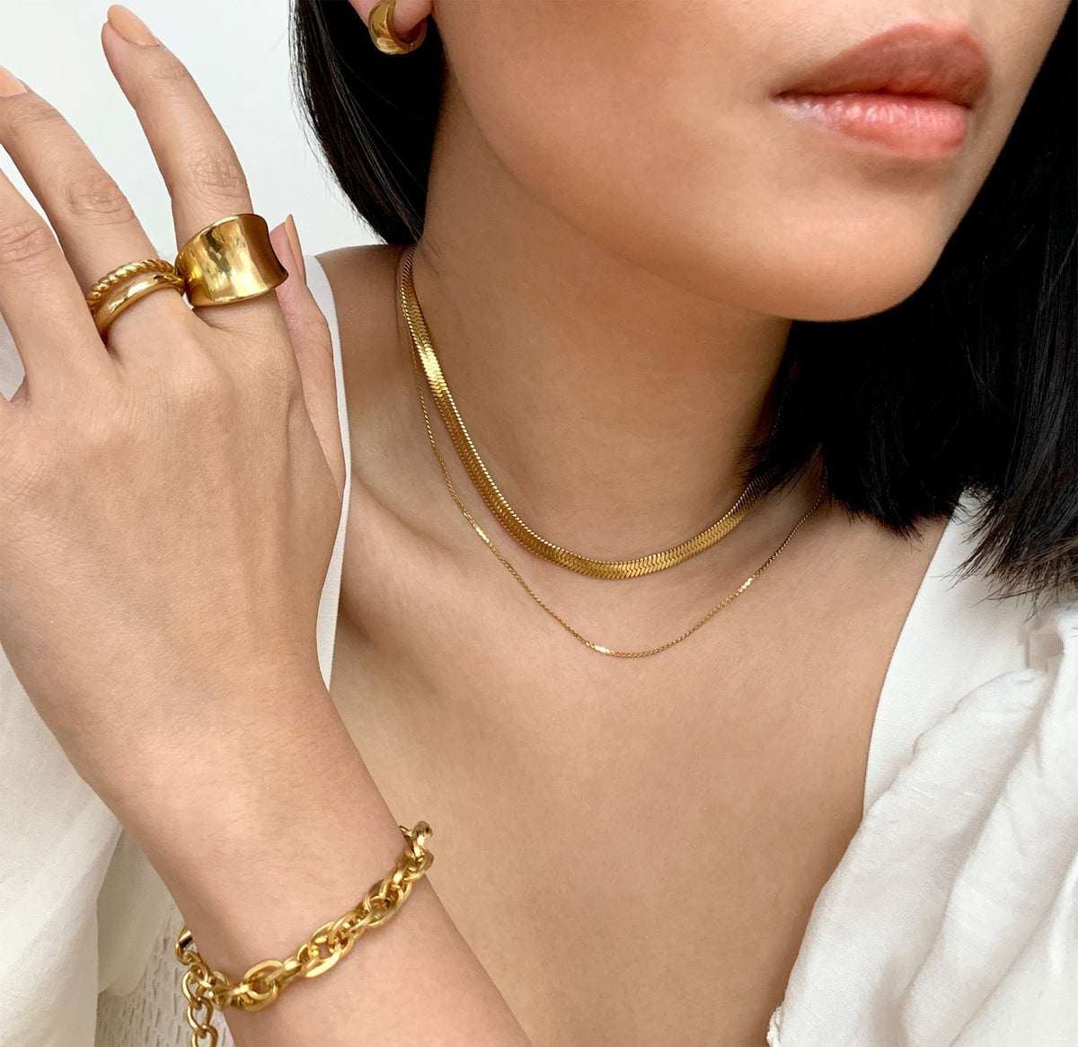 Jordyn gold saddle ring paired with Birdy duo ring band, waterproof jewelry