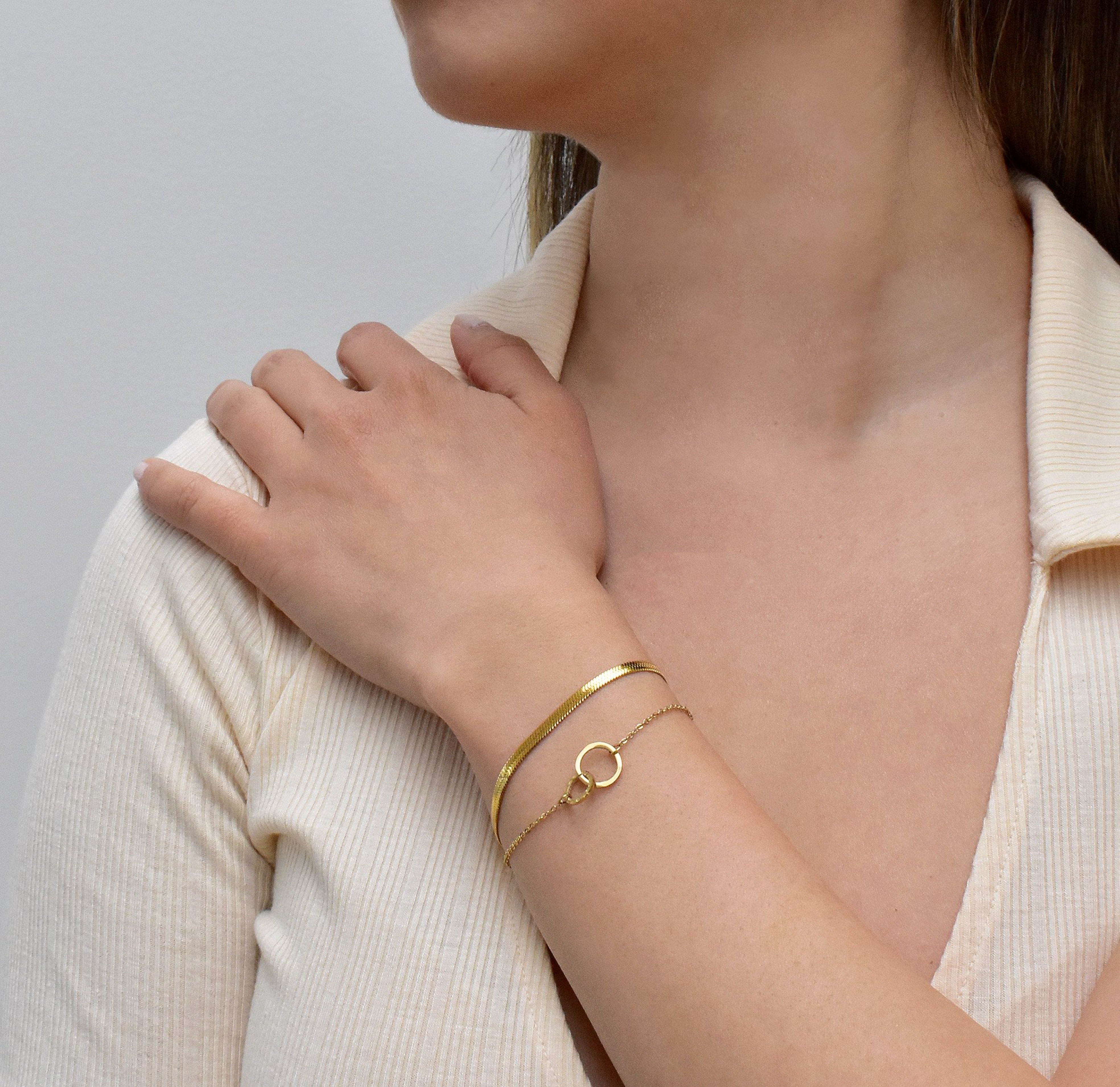 dainty gold unity link bracelet stacked with gold snake chain bracelet waterproof jewelry