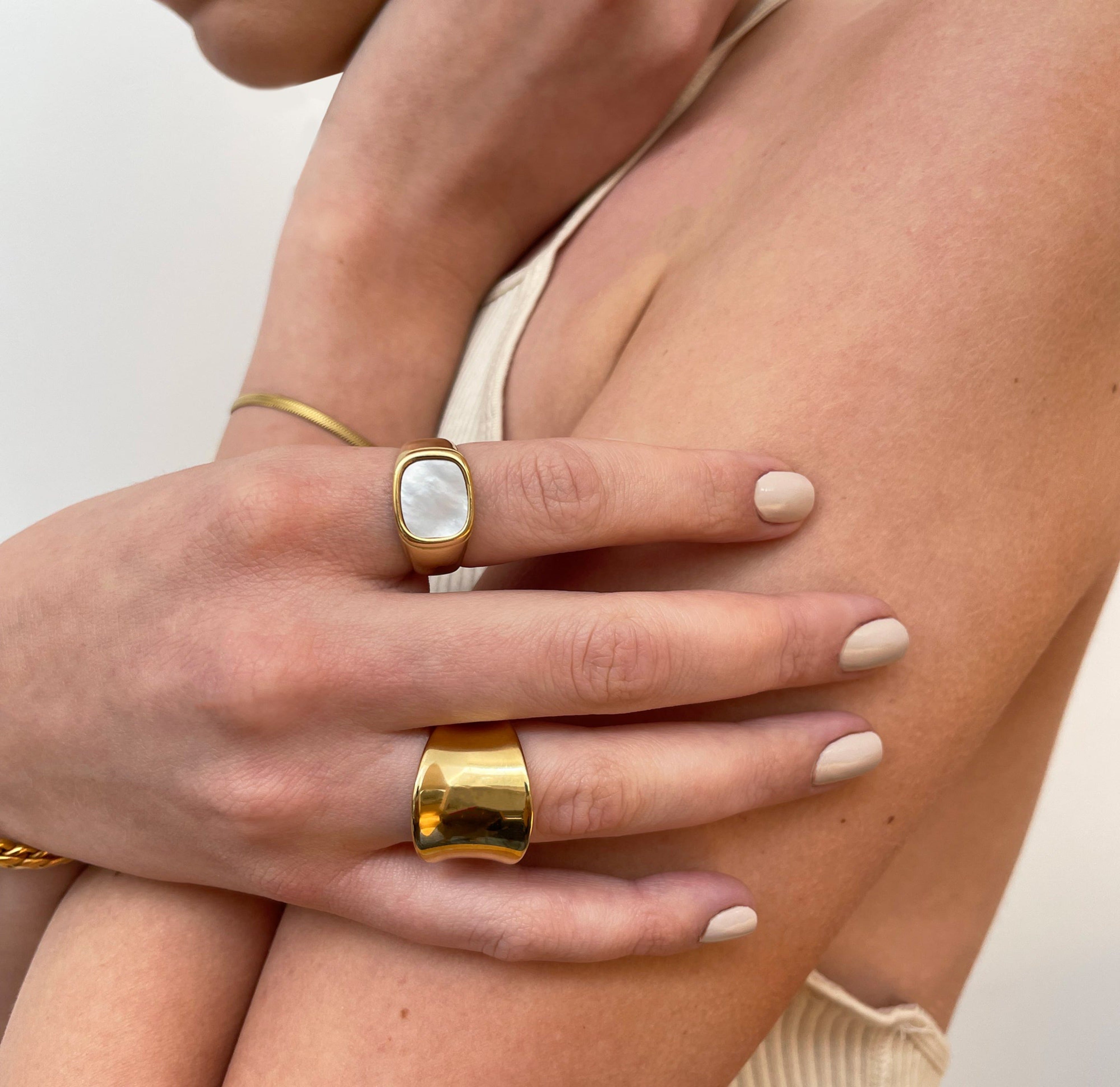 Thea gold square pearl signet ring paired with Jordyn thick saddle ring. Gold waterproof