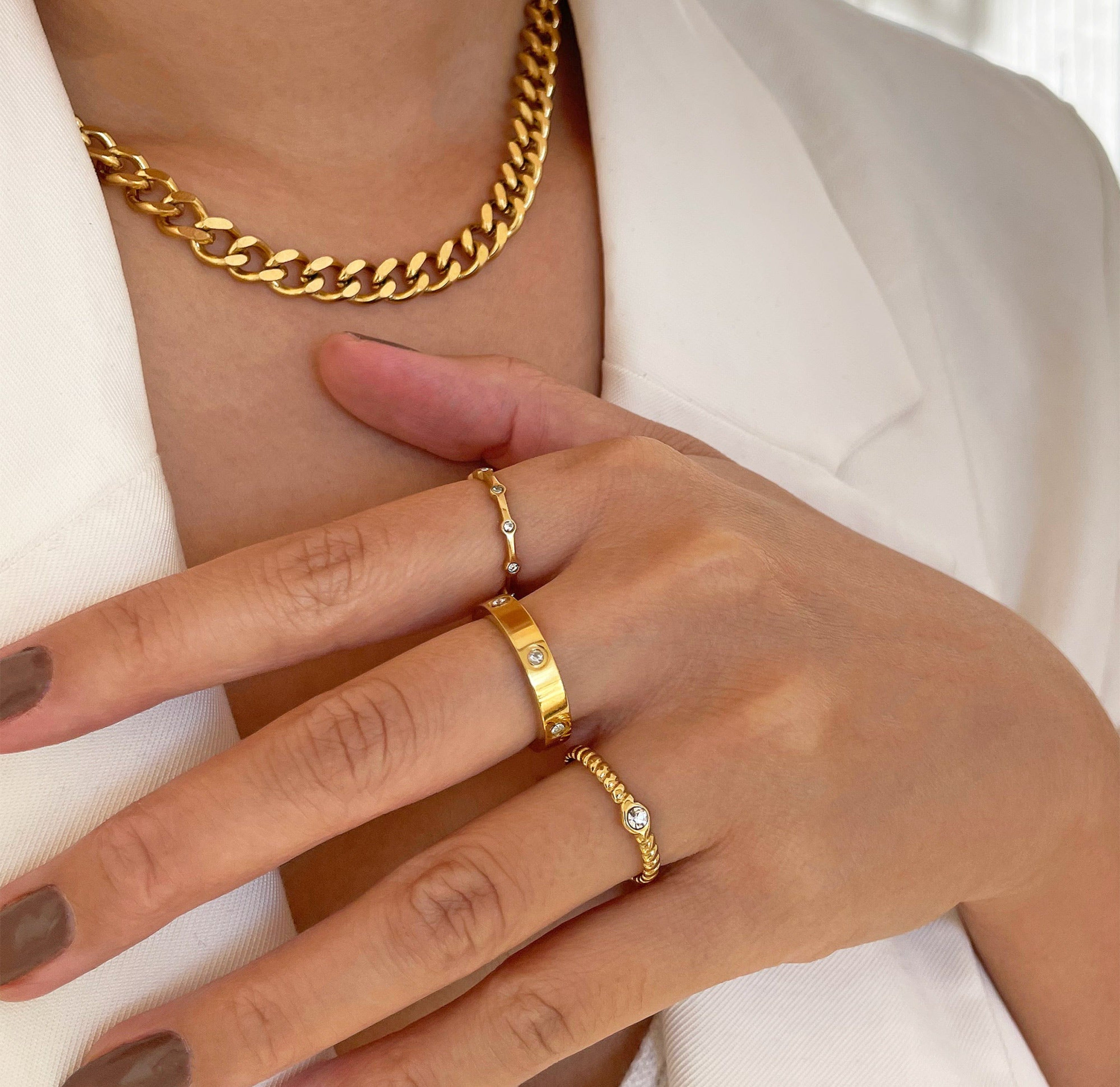 Helena gold adjustable solitaire ring paired with Daphne pave ring, and Carrie ring band. Gold waterproof jewelry