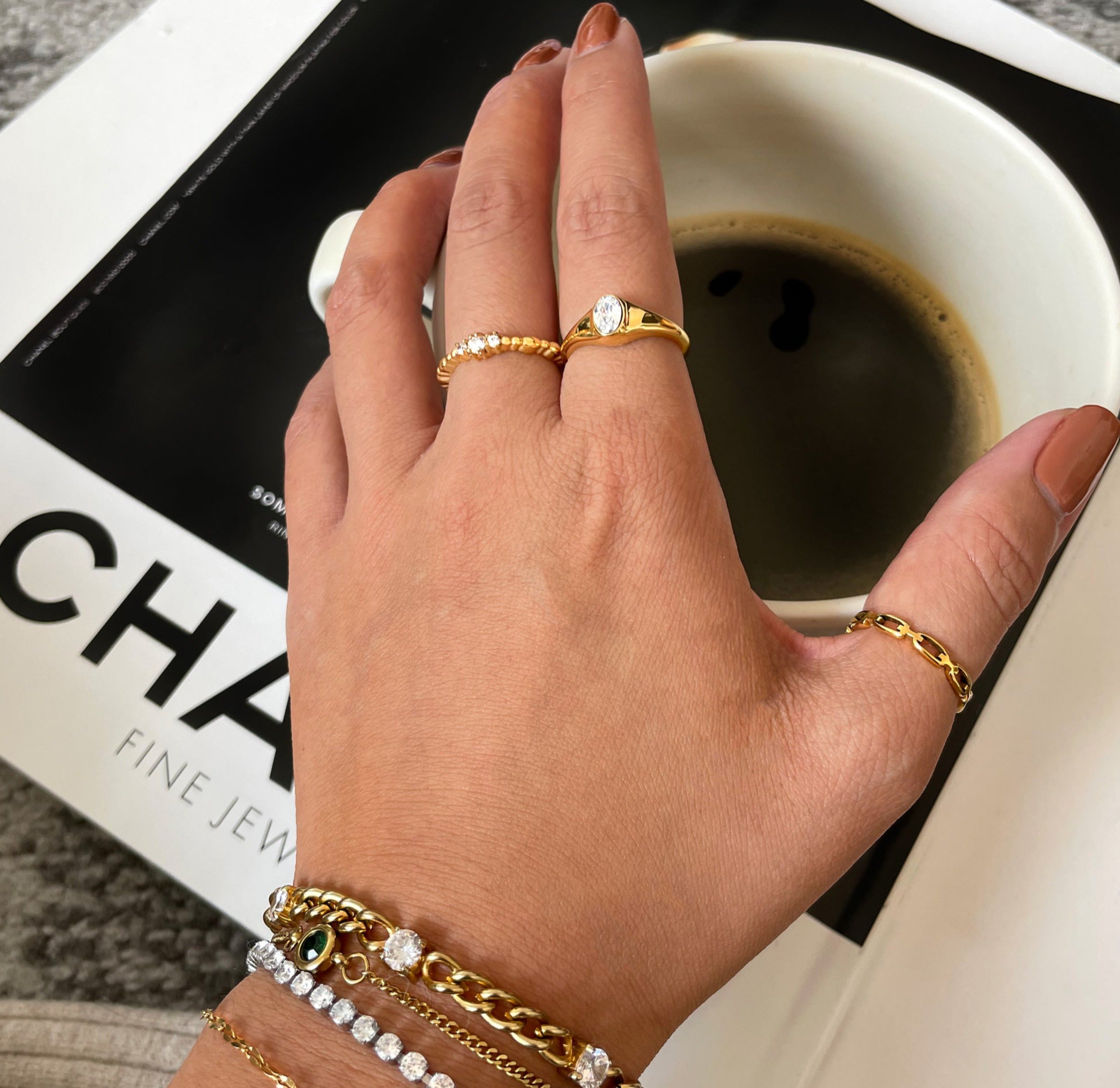 Jeanie gold oval stone ring paired with Bebe thin gold chain ring. Waterproof jewelry