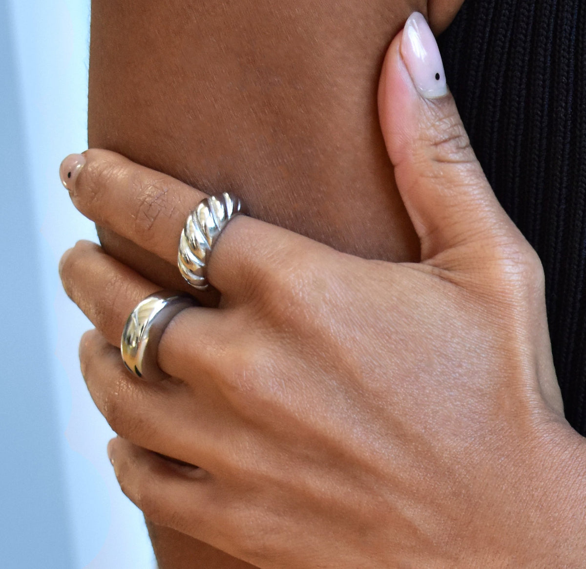 Silver classic croissant ring paired with capri silver dome ring worn on model. Waterproof rings
