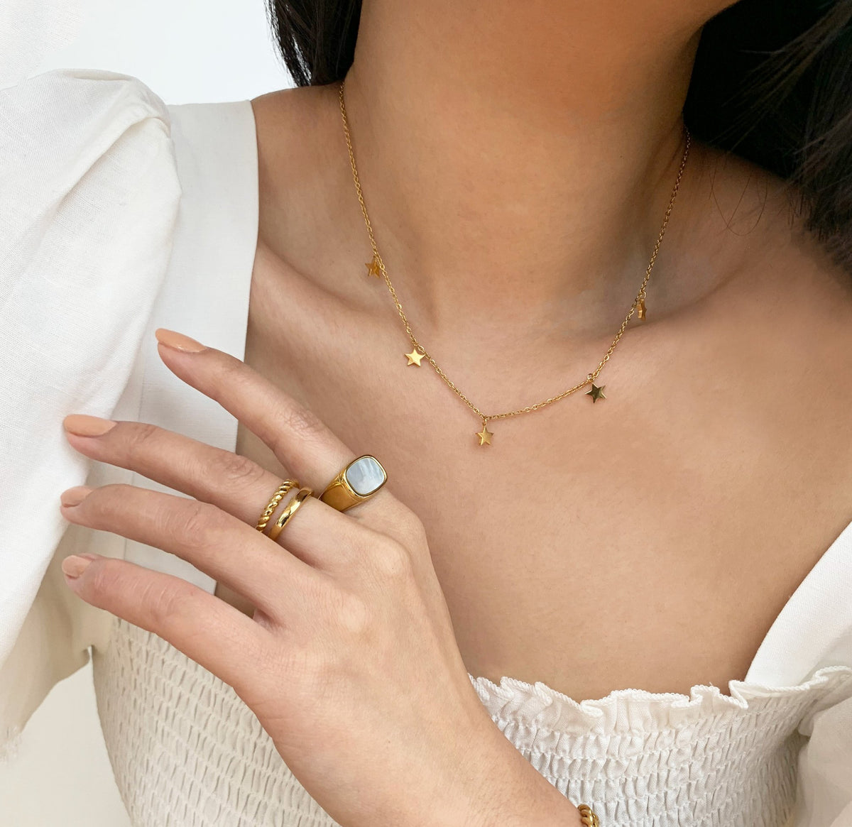 gold birds duo ring band paired with gold Thea pearl signet ring and dainty gold Chloe star necklace waterproof jewelry