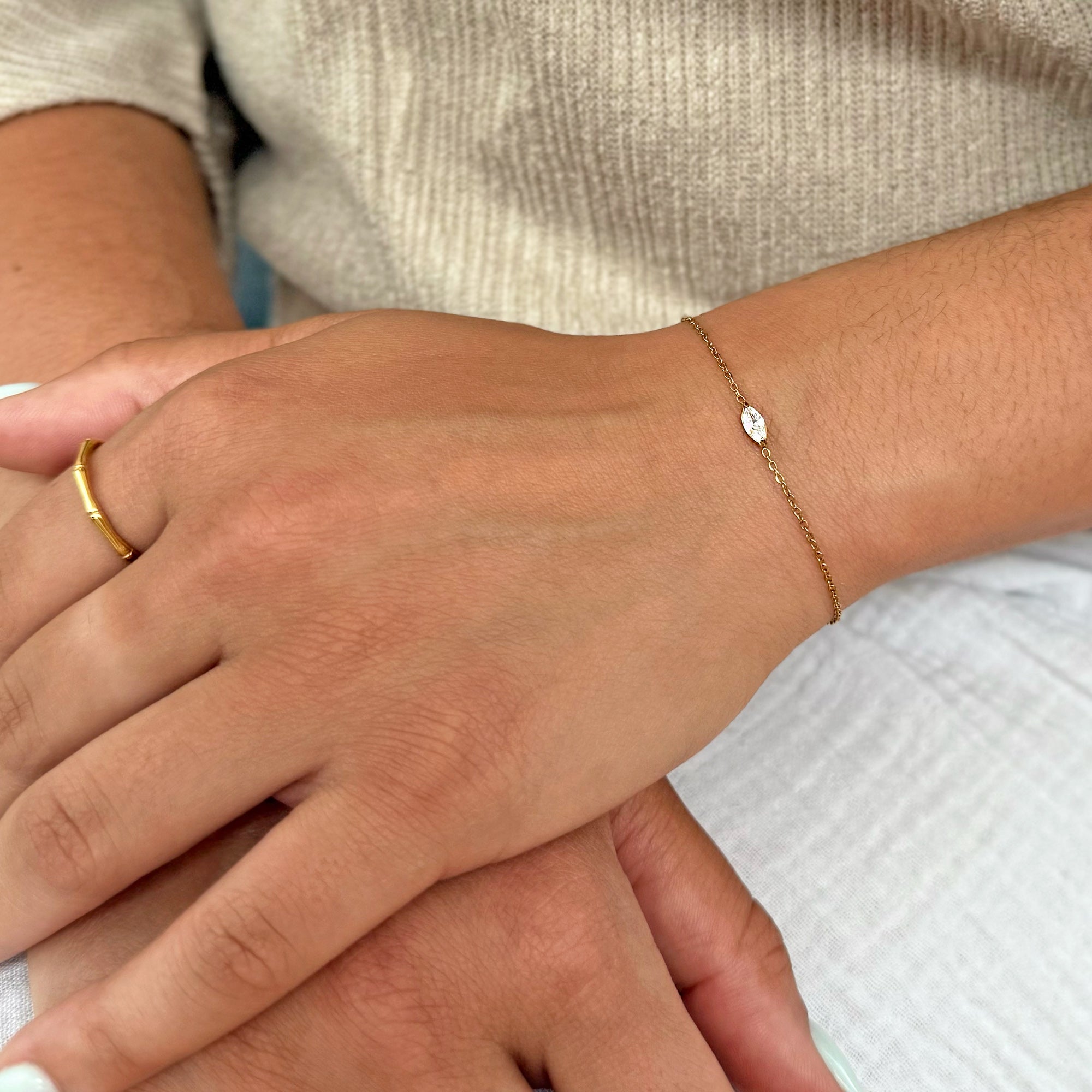 gold dainty marquis stone bracelet worn on model