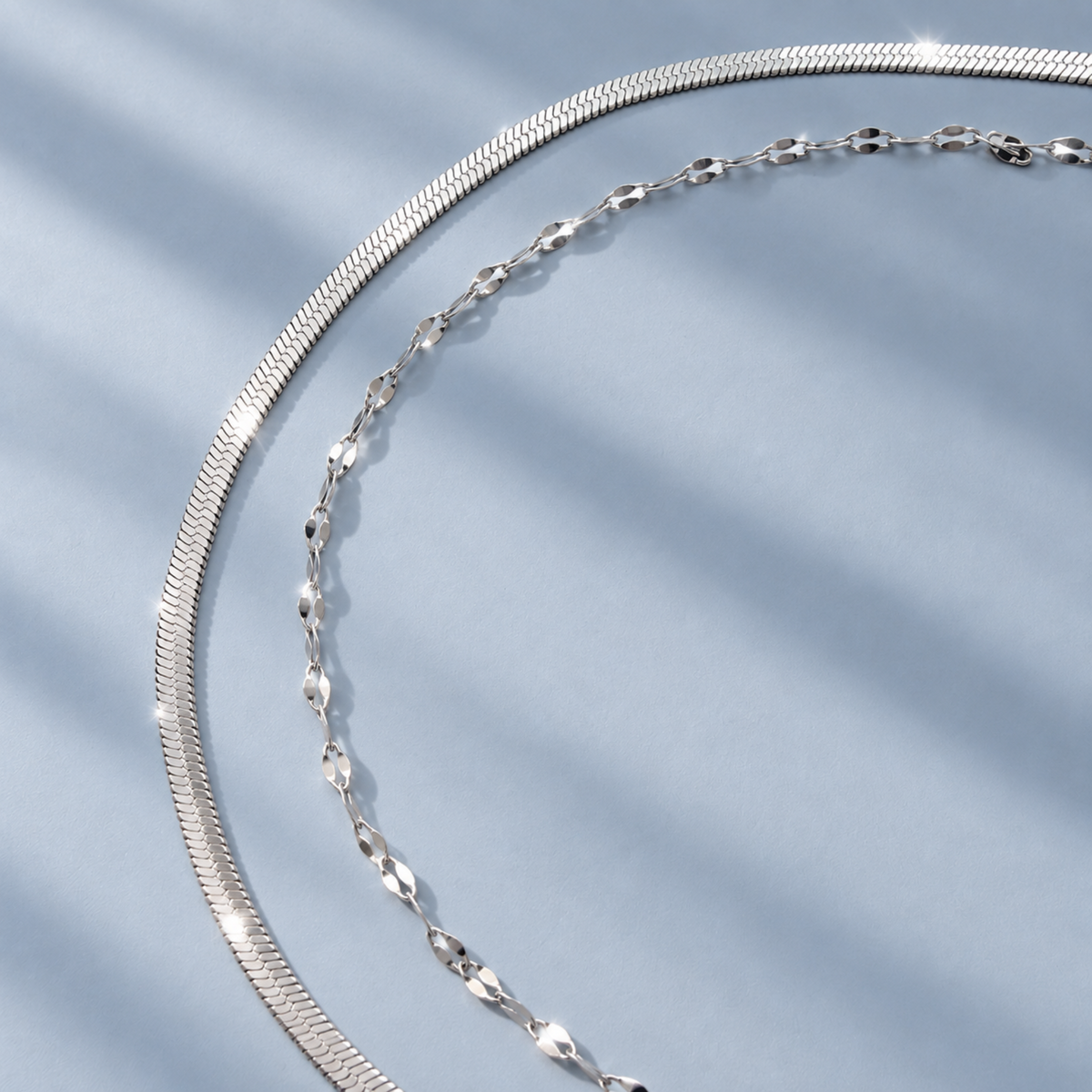 dainty_silver_lace_and_snake_chain_set_waterproof_jewelry flat lay