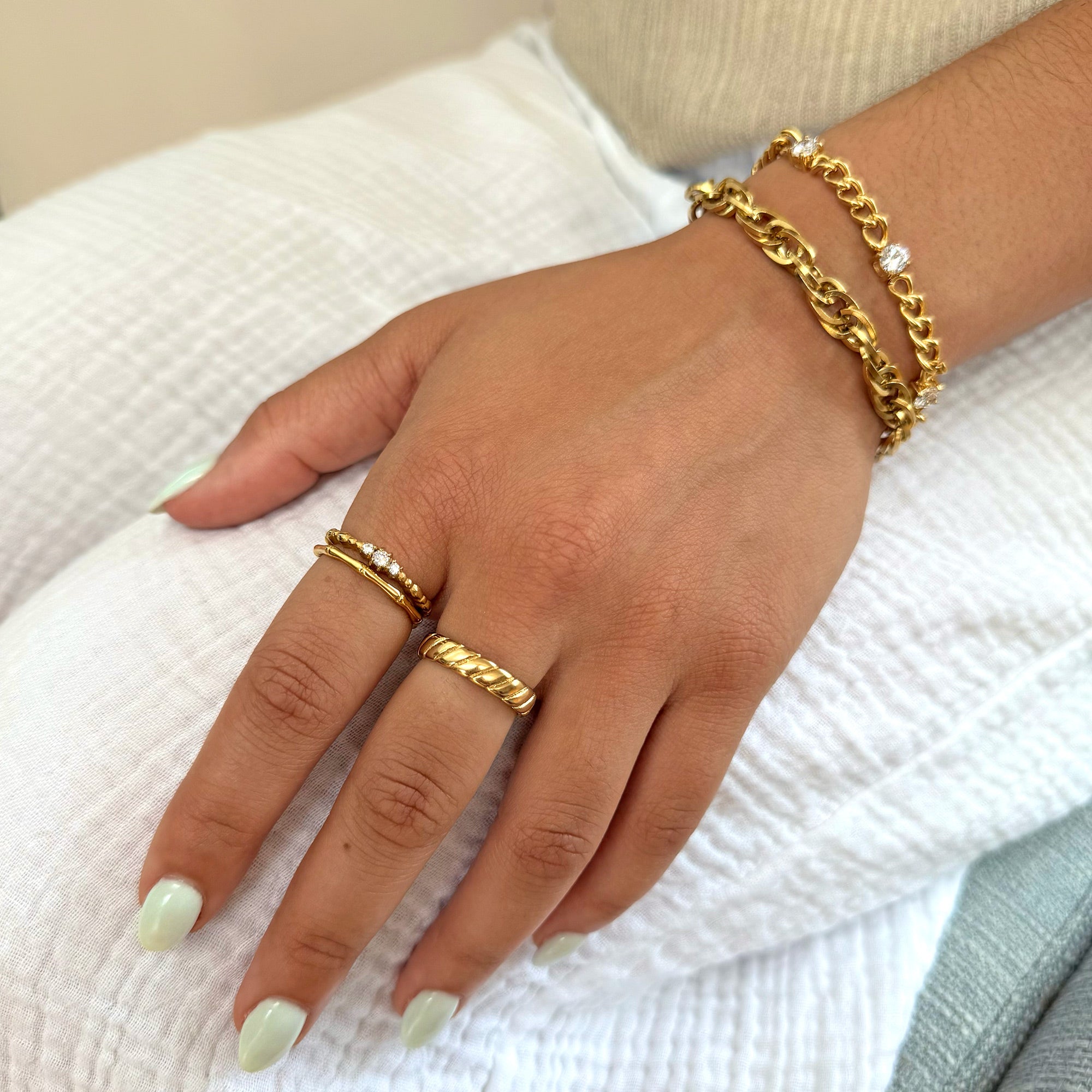 Hand wearing waterproof gold ring stack   tarnish free jewelry