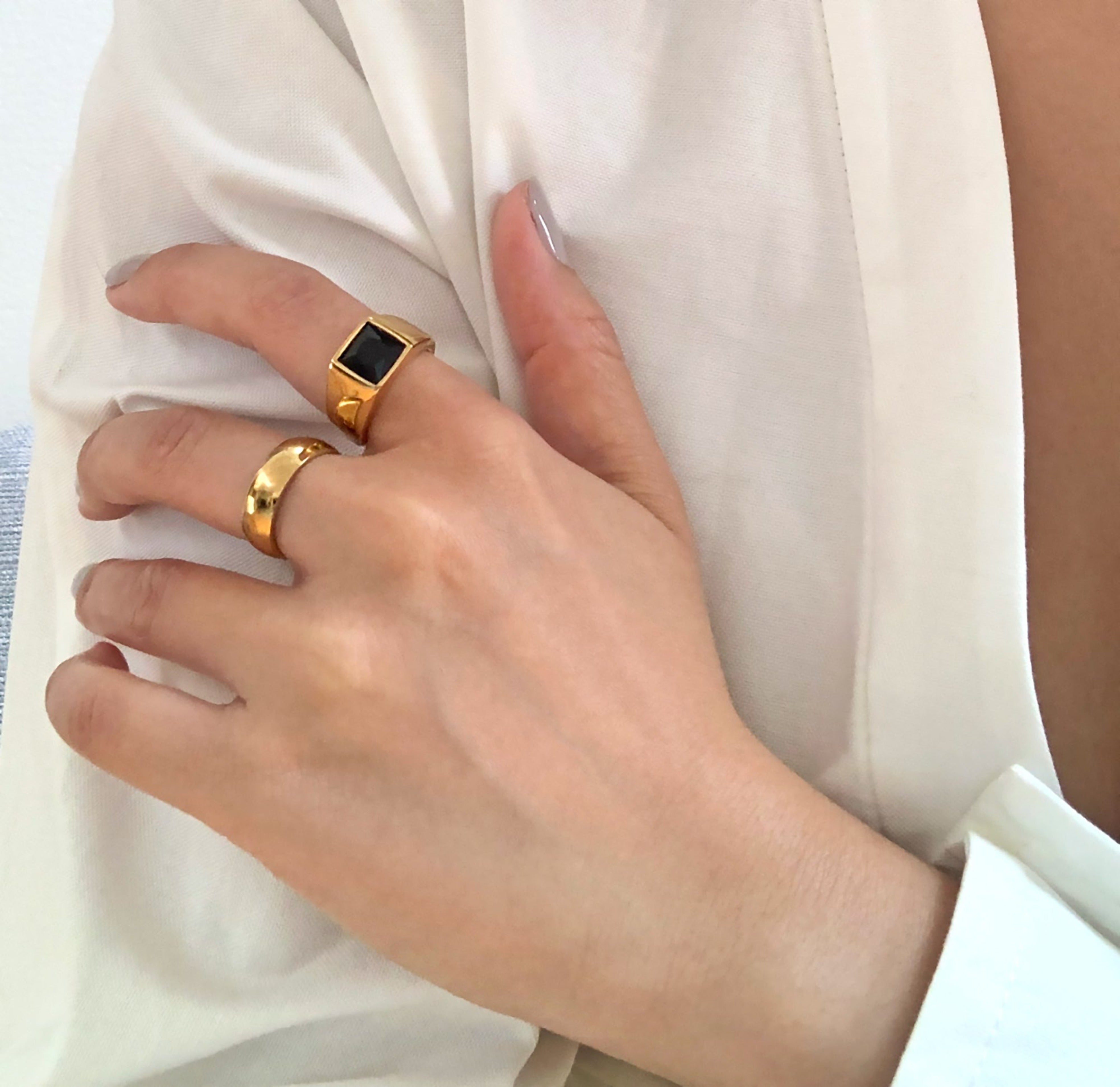 thick gold ring band paired with black onyx square signet ring. Gold waterproof rings