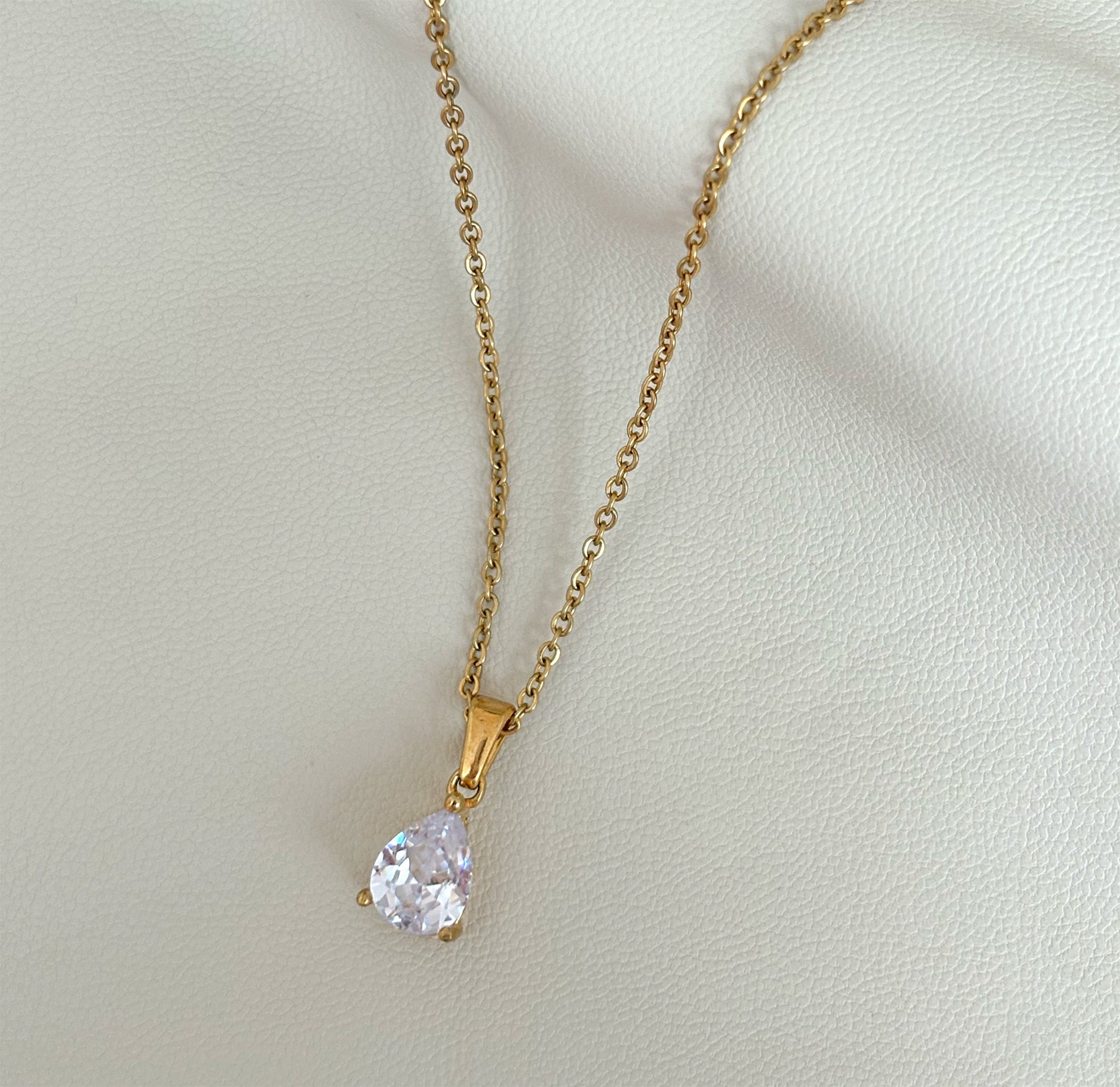 dainty white tear drop stone pendant necklace flat lay
