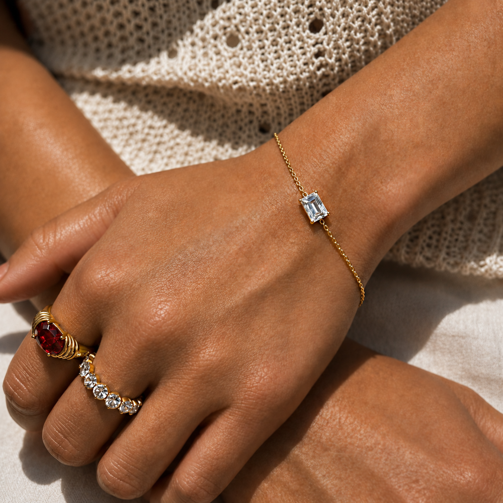 gold dainty emerald cut stone bracelet on model