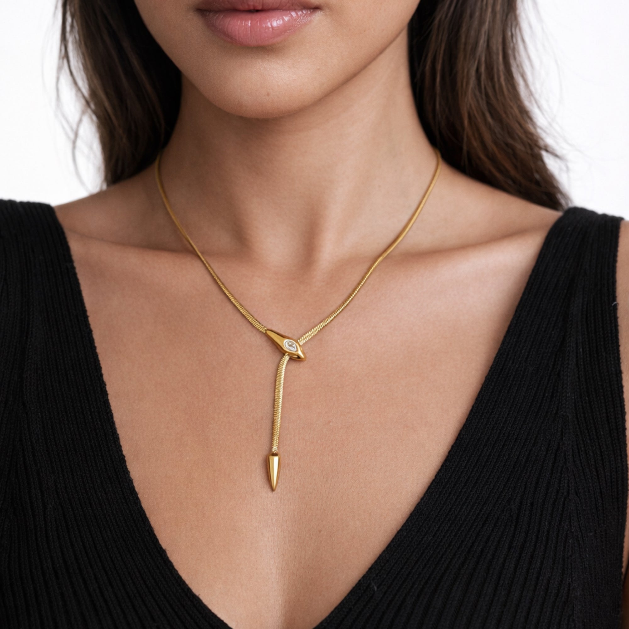 Gold necklace with a unique pendant worn by a model against a white background waterproof jewelry