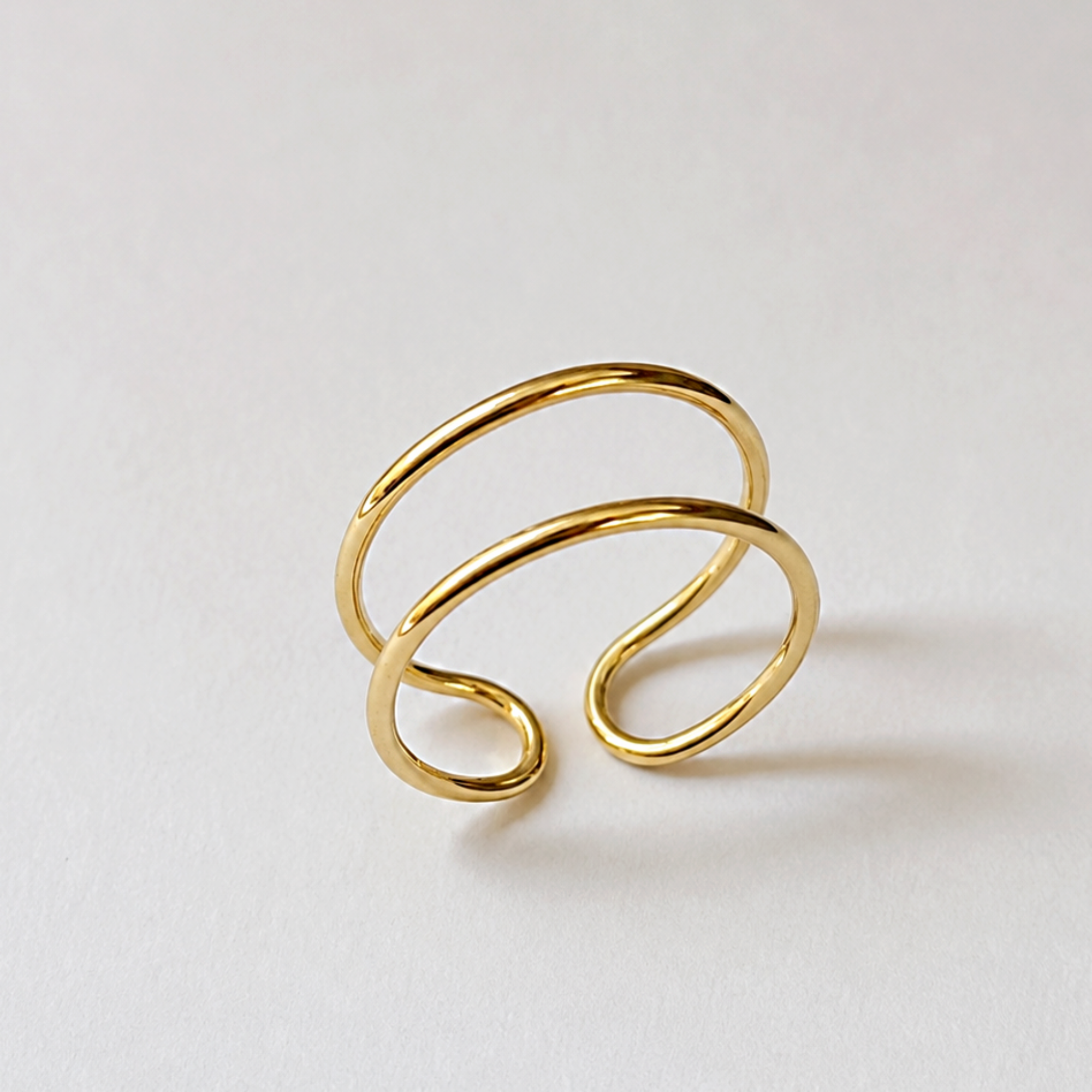 Gold adjustable open duo ring on a light gray background