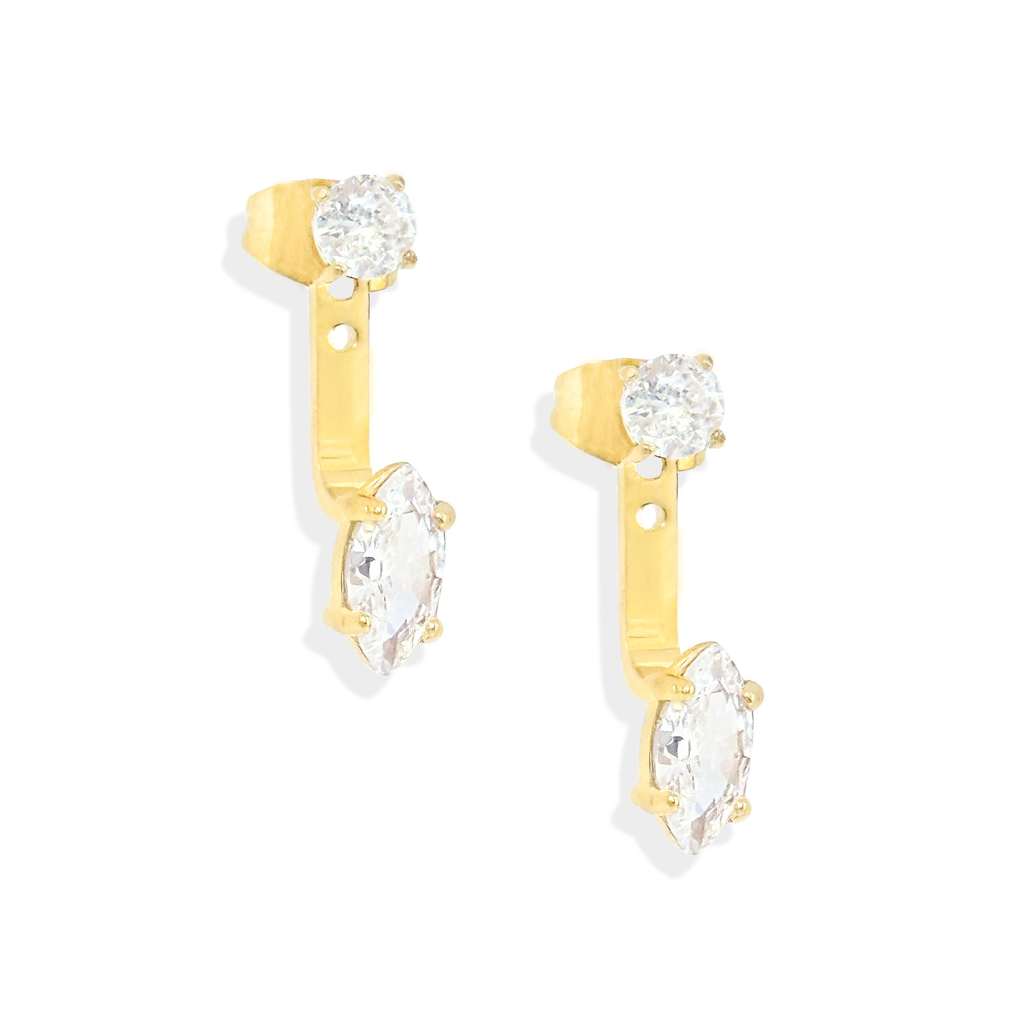 Gold earrings with clear gemstones on a white background