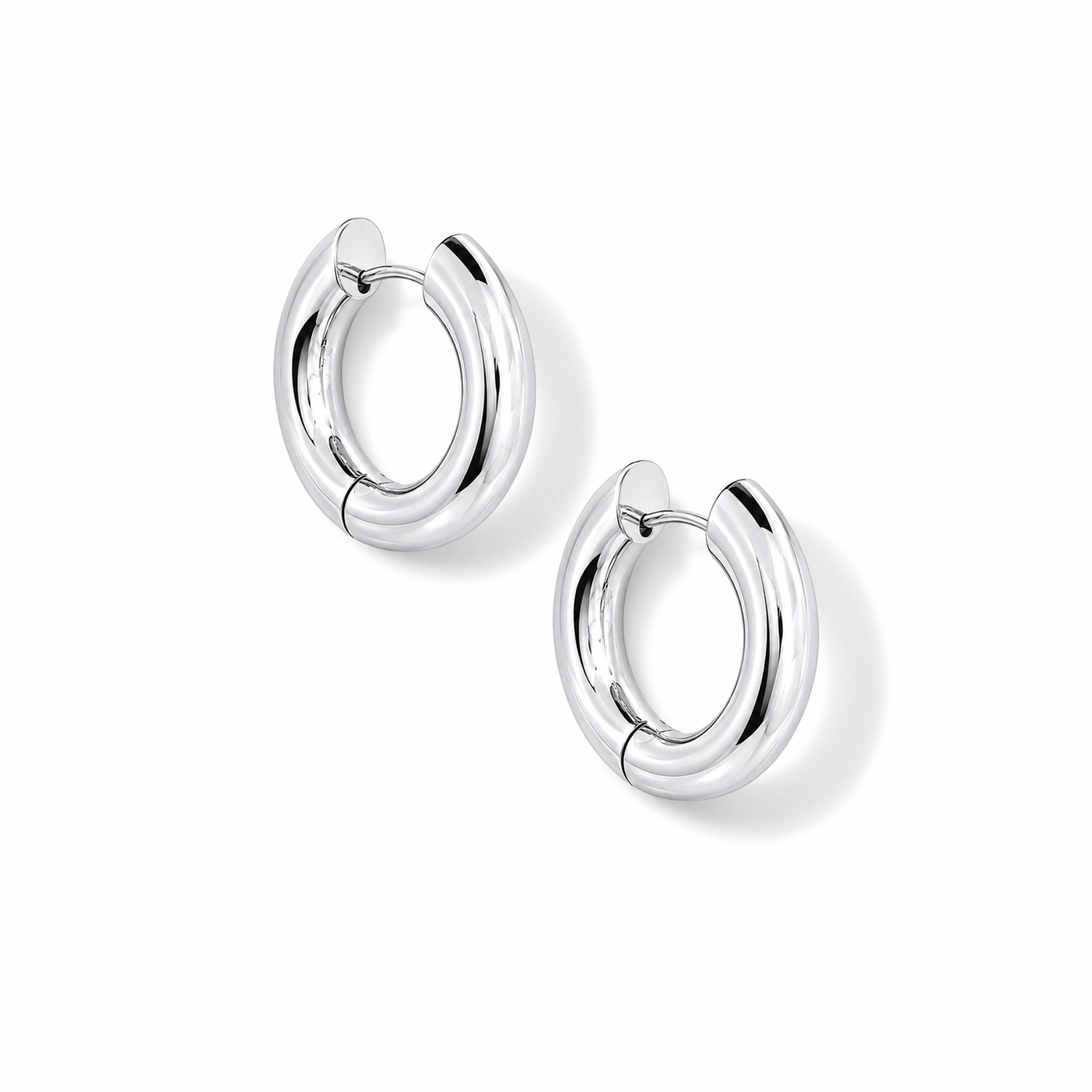 Pair of chunky silver hoop earrings on a white background