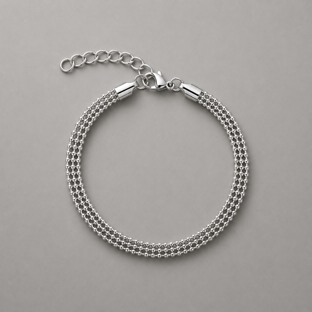 Silver beaded chain bracelet on a gray background