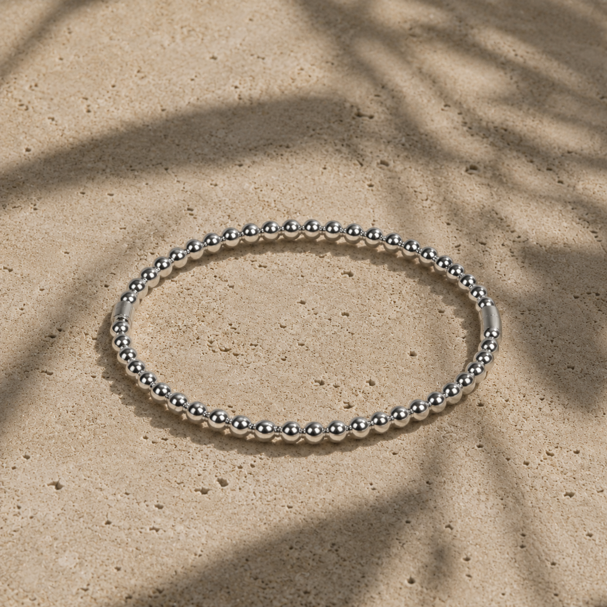 silver beaded cuff bracelet on stone ground