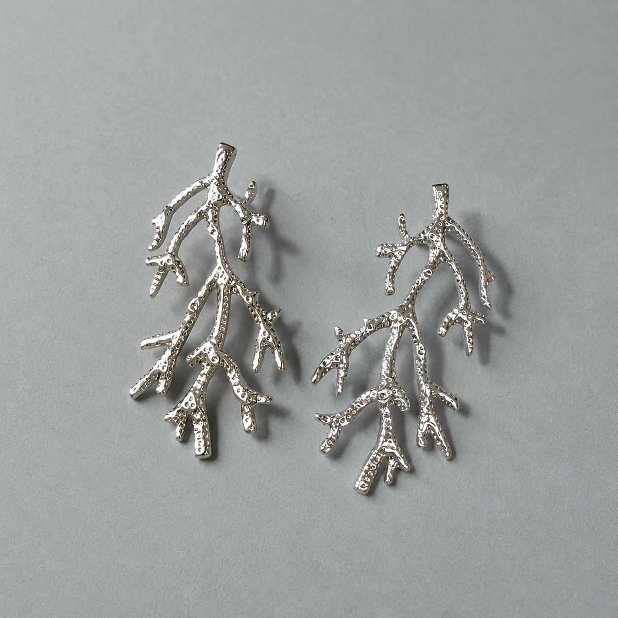 silver coral earrings waterproof jewelry on grey background