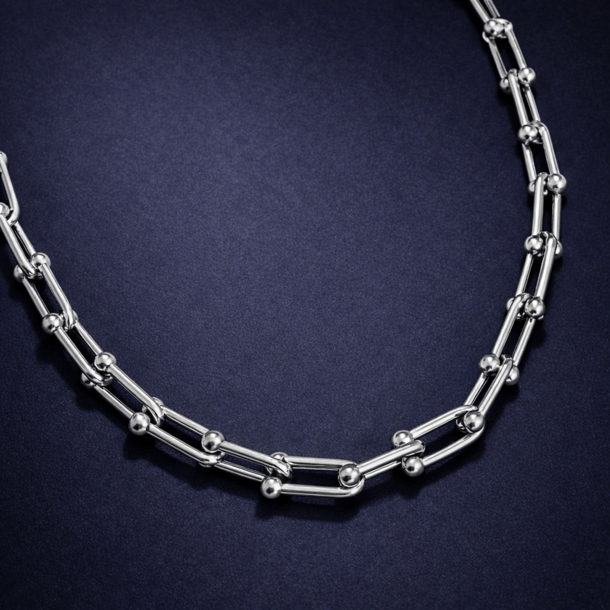Silver necklace on a dark blue background