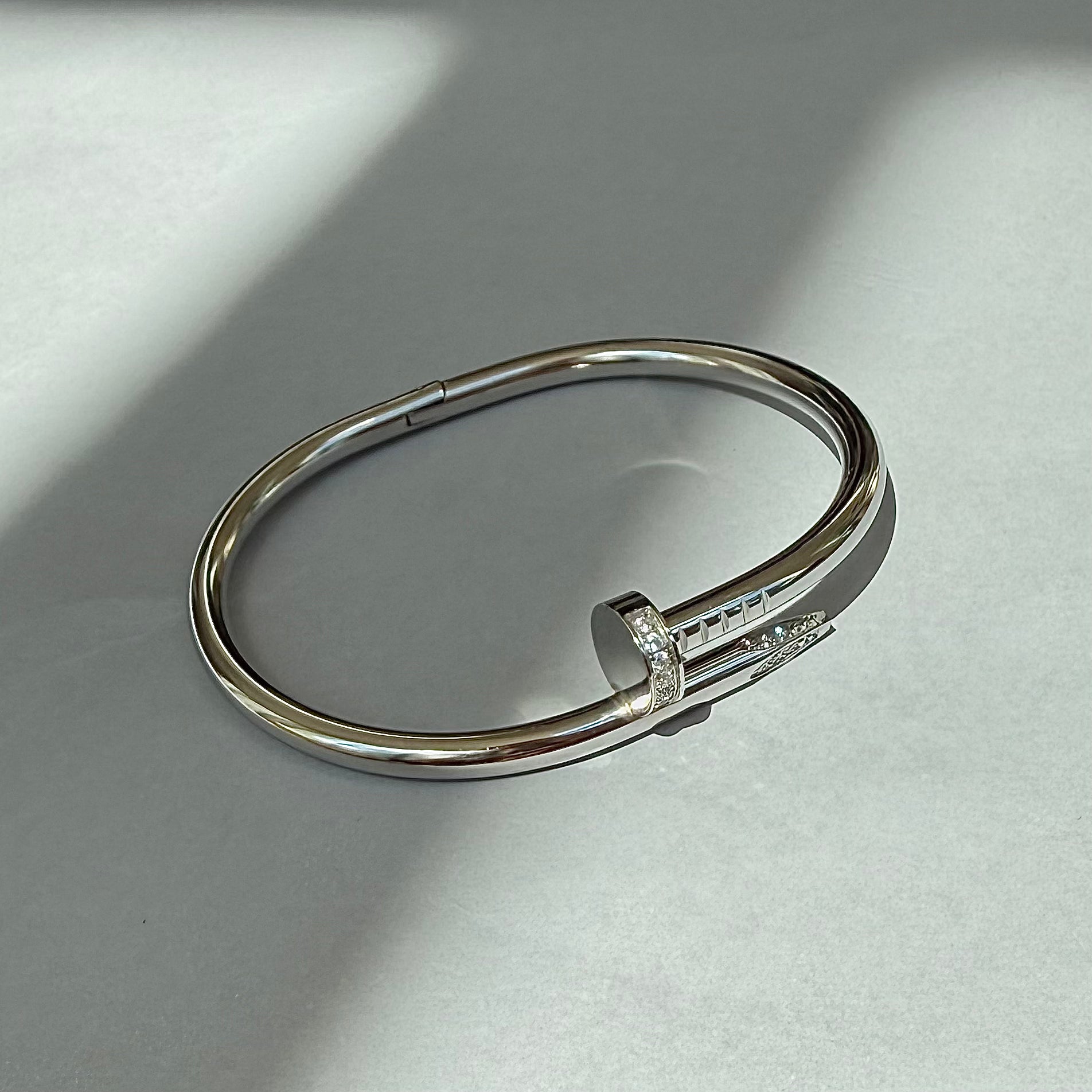 silver pave cuff bracelet on grey background