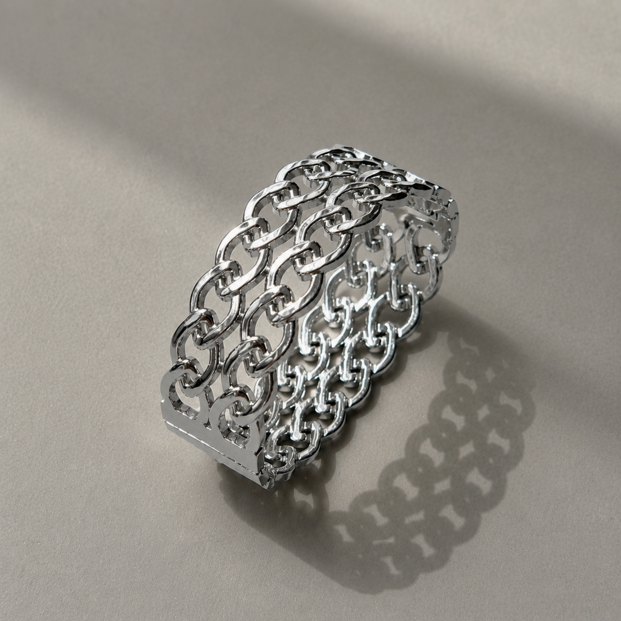 silver woven cuff bracelet on grey background